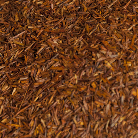 Close-up of deep red Organic Rooibos Tea, naturally caffeine-free and rich in antioxidants, perfect for a soothing beverage.