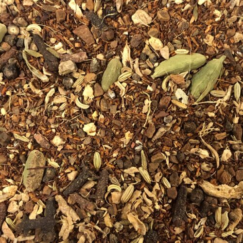 Close-up of Cinnamon Rooibos Tea blend, featuring a rich mix of cinnamon, cardamom, cloves, and other spices.